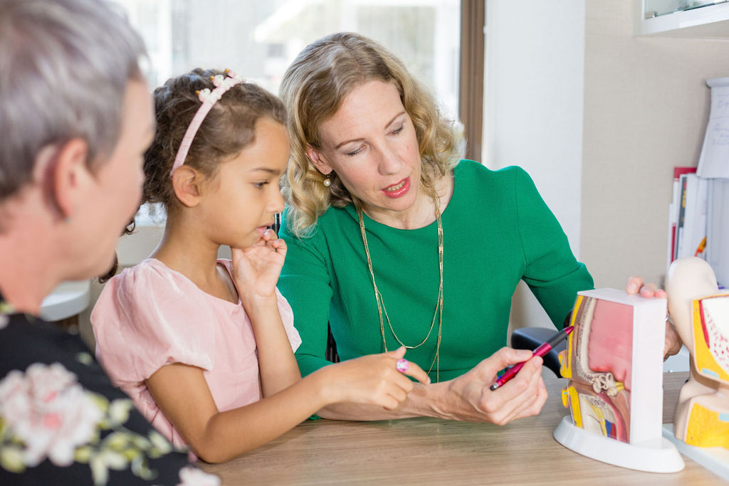 dr rebecca heywood teaching a child