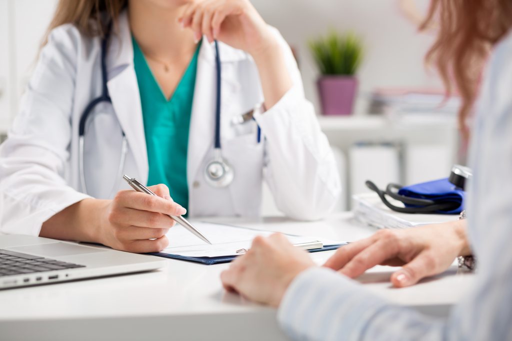 closeup of a doctor consulting a patient in her clinic